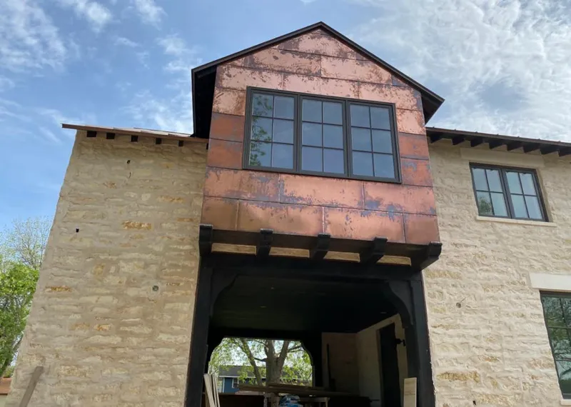 Copper metal panel facade on a stone building for Skylight Installation in South Whittier